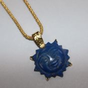 A yellow metal and lapis lazuli `moonface' pendant on 22ct yellow gold suspension chain pendant