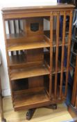 A revolving bookcase by Trubner & Co, H.118cm