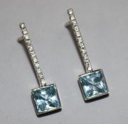 A pair of aquamarine and diamond modernist drop earrings in white metal settings, (one butterfly