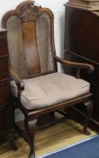 A Carolean walnut and wicker elbow chair