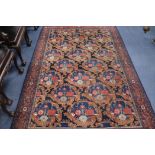 A Persian blue ground carpet, woven with stylised shrubs 260 x 170cm