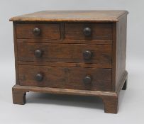 An oak miniature chest of drawers