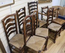 An early 19th Century elm ladderback rush-seat elbow chair, 5 similar dining chairs, a Regency