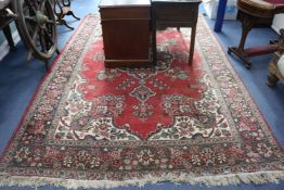 A modern Persian red-ground carpet with polychrome figured floral central medallion, 330cm x 220cm