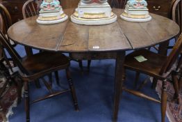 An oak oval drop-leaf table fitted single drawer, W.140cm (with leaves extended)