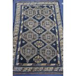 A Caucasian blue ground rug, 170 by 110cm