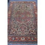 An Isphahan red and cream medallion rug 240 x 140cm