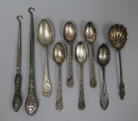 Two silver handled button hooks, a sterling silver teaspoon, a silver preserve spoon and five plated