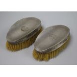 A pair of 1920's engine turned silver mounted clothes brushes by Walker & Hall, Sheffield, 1929,