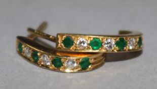 A pair of 18ct gold, emerald and diamond earrings.