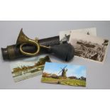 A quantity of postcards, a brass horn and a telescope