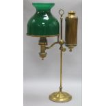 A brass student's lamp with green glass shade