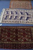 A Bokhara rug and two others, 110 x 75cm, 140 x 80cm & 125 x 70cm