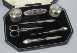 A cased 1920's silver mounted seven piece manicure set.