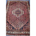 A Persian red ground rug, 195 x 145cm