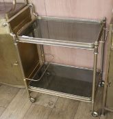 A two tier glass and brass tea trolley, H.76cm