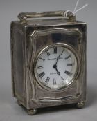 A sterling silver carriage timepiece, retailed by Elliott & Son, London, with Roman dial, on bun