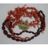 A simulated cherry amber necklace, a freeform coral necklace and an agate set clasp.