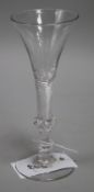 A wine glass, c.1750, with flared bowl, over a knopped airtwist stem, 6.75in.