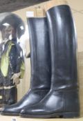 A pair of leather riding boots with boot stretchers