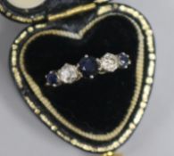 A 1980's 18ct gold, five stone sapphire and diamond half hoop ring, size L.