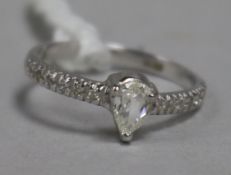 A modern 14ct white gold and pear shaped single stone diamond ring, with diamond set shoulders, size