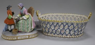 A Continental porcelain group and a faience basket