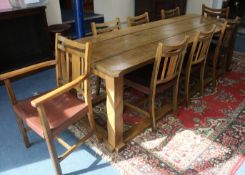 A 17th century style oak plank topped refectory table and eight oak dining chairs, by Derek Hyatt