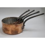 A set of five graduated copper saucepans