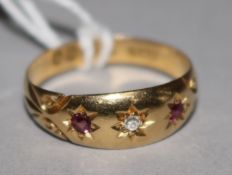 An early 20th century 18ct gold ruby and diamond gypsy set ring, size R.