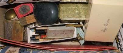 A brass hoof inkwell, a World War II cigarette tin and various pens, etc