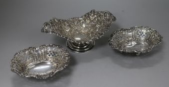 A pair of late Victorian pierced repousse silver sweetmeat dishes and a similar repousse silver