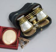 A 19th century pinchbeck fob seal with carnelian matrix, a pair of mother of pearl opera glasses and