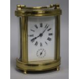 A French brass oval carriage timepiece with alarm