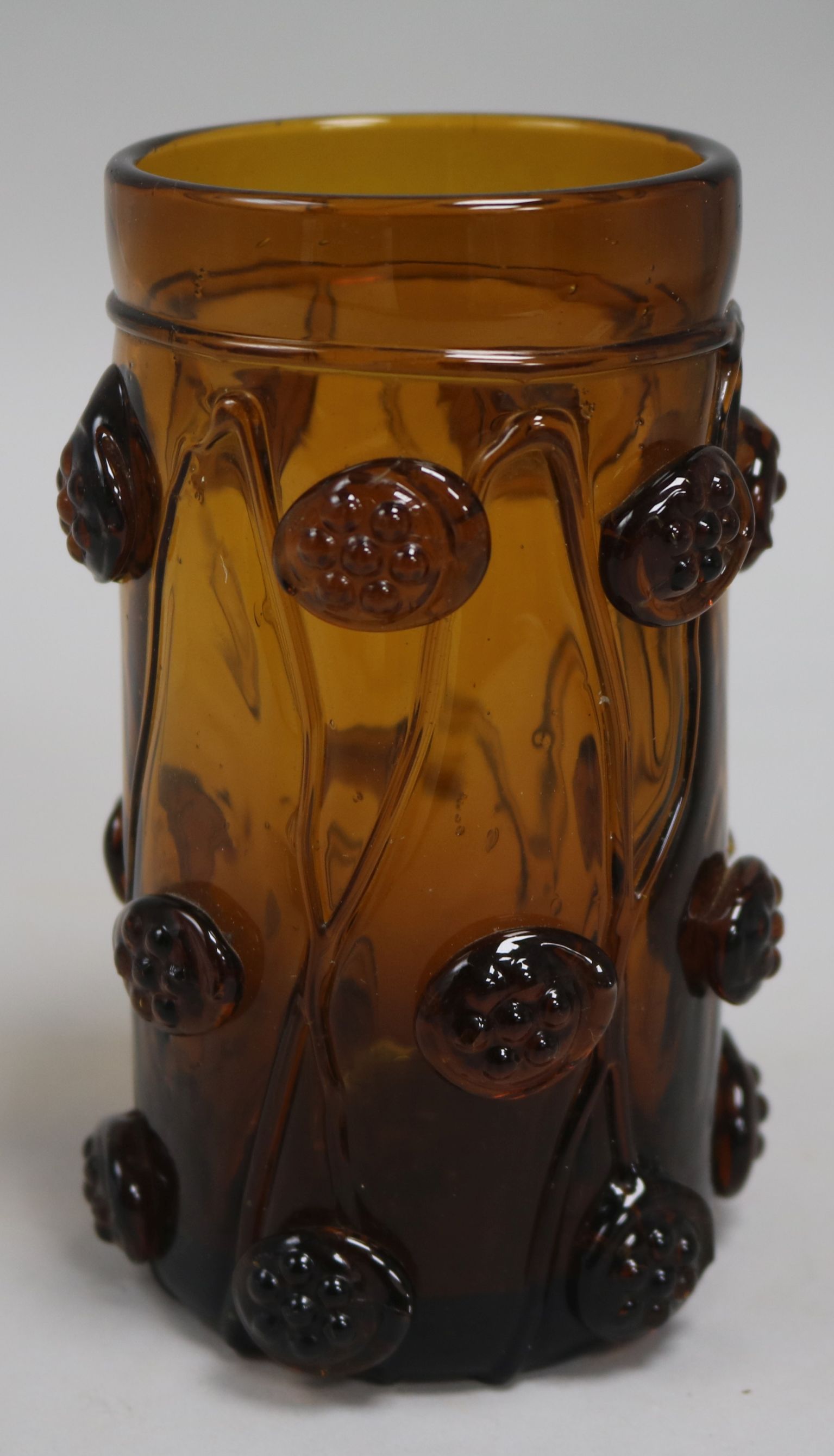 A Rheinish amber glass humpen, decorated with "raspberry prunts", 5.75in.