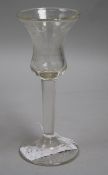 A Dutch tall wine glass with bell bowl, engraved with a floral reserve and inscribed "Hence we