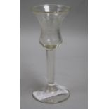 A Dutch tall wine glass with bell bowl, engraved with a floral reserve and inscribed "Hence we