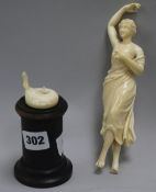 A carved ivory figurine on stand