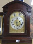 An Edwardian walnut mantel clock