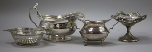 A silver sauce boat, a silver oval small sugar bowl, a pierced silver two-handled sweetmeat dish and