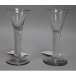 A near pair of ale glasses, c.1750, with flared bowls over air twist stems, 6in.