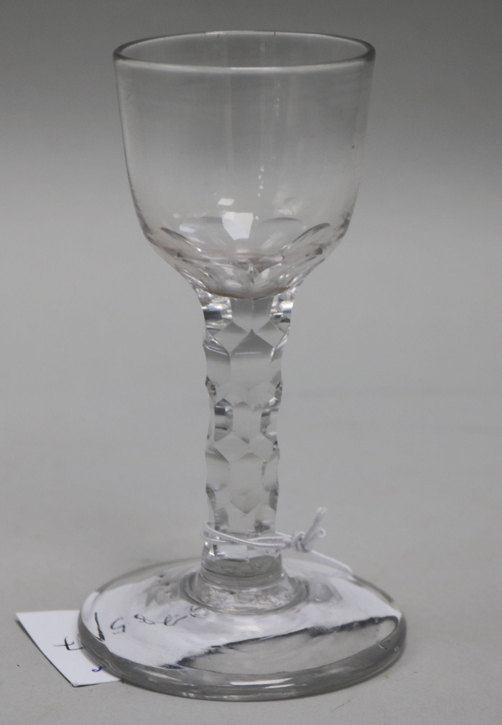 A wine glass, c.1785, with round bowl over a faceted stem, 4.75in.