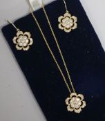 A 14ct gold and diamond flowerhead pendant on a 14ct gold fine link chain and a pair of matching