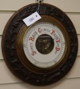 A Victorian carved oak aneroid barometer W.36cm
