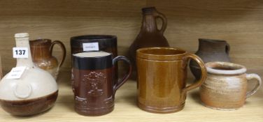 A staved oak grain measure, six various earthenware jugs, mugs, a vase and a 17th century saltglazed
