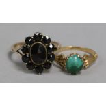 A 9ct gold and garnet cluster ring and a gold and turquoise ring.