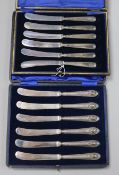 Two cased sets of six silver handled cake knives.