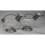 A pair of pewter mounted glass claret jugs