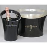 A Moet metal ice bucket and a later plastic bucket designed by Jean Maregady
