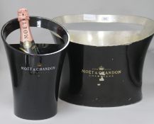 A Moet metal ice bucket and a later plastic bucket designed by Jean Maregady